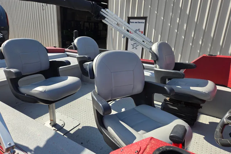Slide: The Image of 2023 SeaArk ProCat 240 boat interior with four gray seats and red accents. - 11