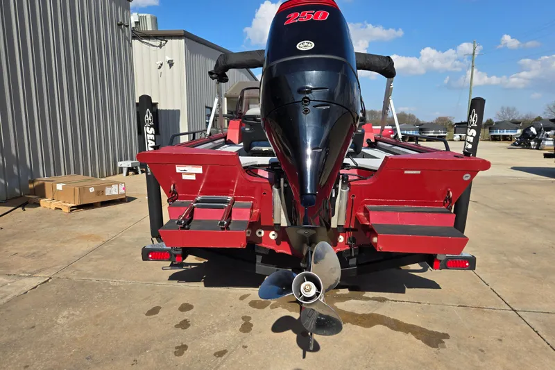 Slide: The Image of 2023 SeaArk ProCat 240 boat with powerful outboard motor, parked outdoors. - 15