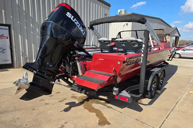 Slide: The Image of 2023 SeaArk ProCat 240 boat with Suzuki outboard motor, parked on a trailer. - 16