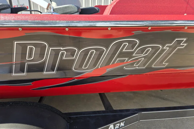 Slide: The Image of 2023 SeaArk ProCat 240 boat with bold graphics and red accents. - 19