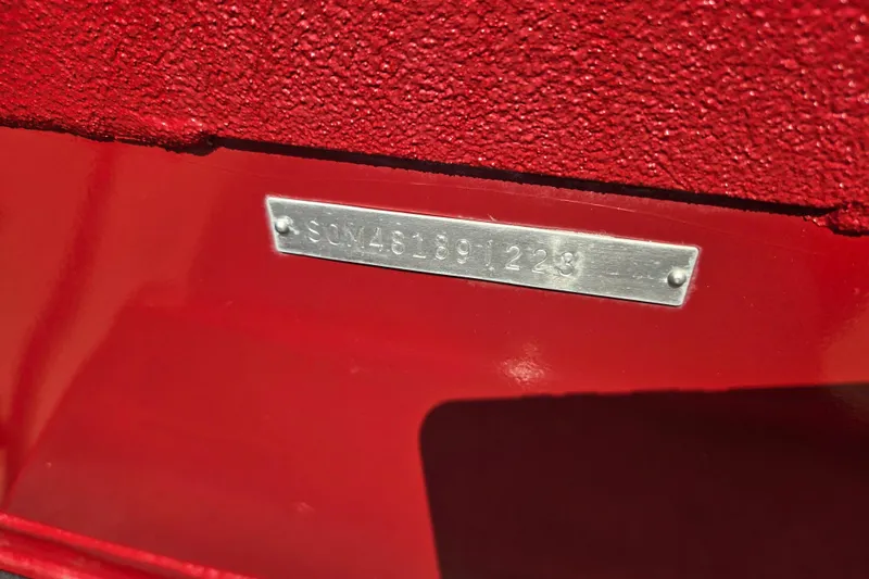 Slide: The Image of 2023 SeaArk ProCat 240 boat identification plate on red surface. - 21