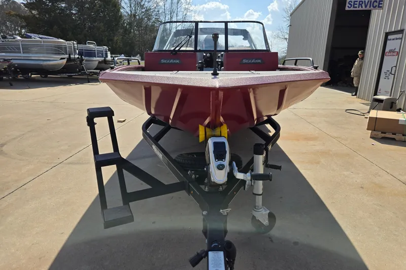 Slide: The Image of 2023 SeaArk ProCat 240 boat on trailer, parked outdoors near service area. - 5