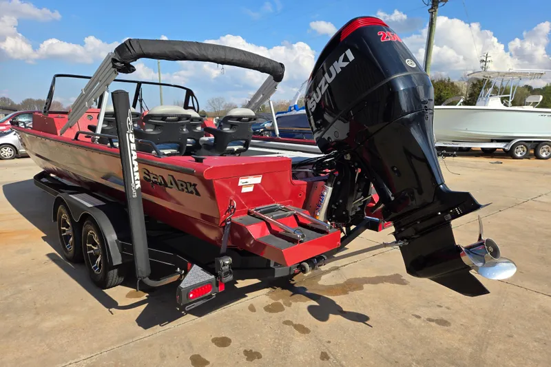Slide: The Image of 2023 SeaArk ProCat 240 boat with Suzuki outboard motor, parked on a trailer. - 7