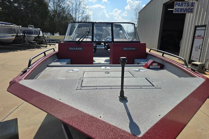 Slide: The Image of 2023 SeaArk ProCat 240 boat at service center, showcasing spacious deck and windshield. - 8