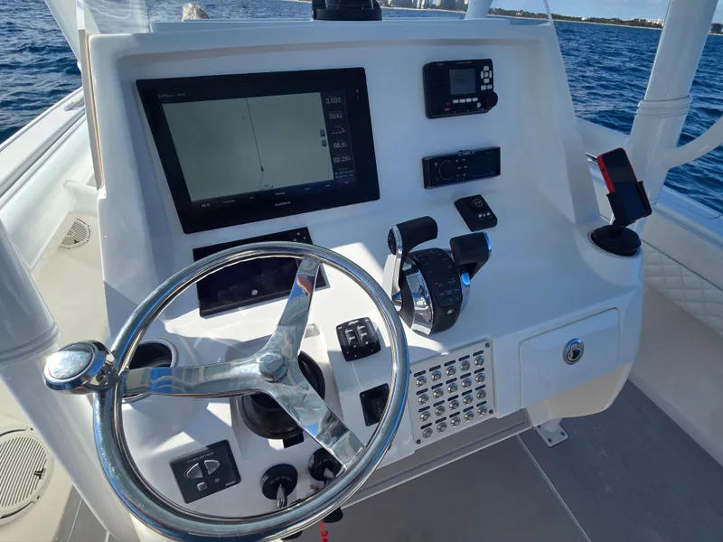 Slide: The Image of Helm console of a 2019 Intrepid 327 boat on the water. - 11
