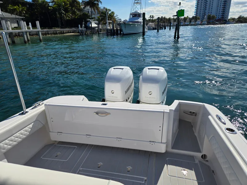 Slide: The Image of 2019 Intrepid 327 boat with twin outboard engines on water. - 12