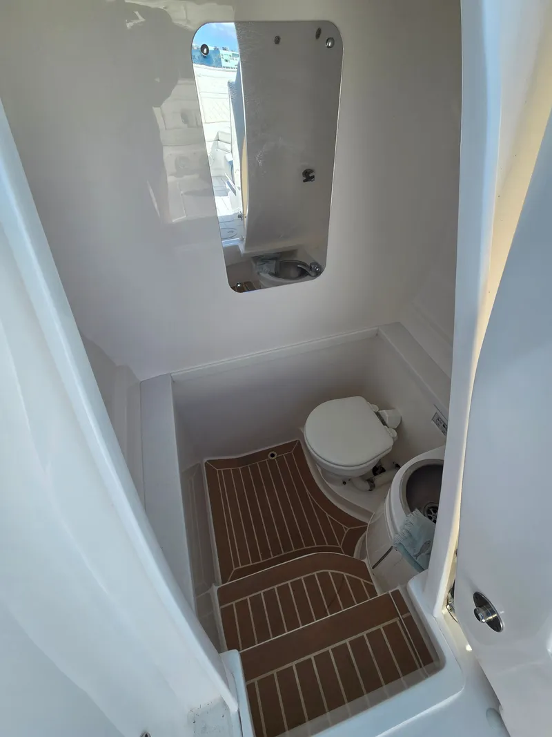 Slide: The Image of Interior of a 2019 Intrepid 327 yacht with toilet and mirror. - 15