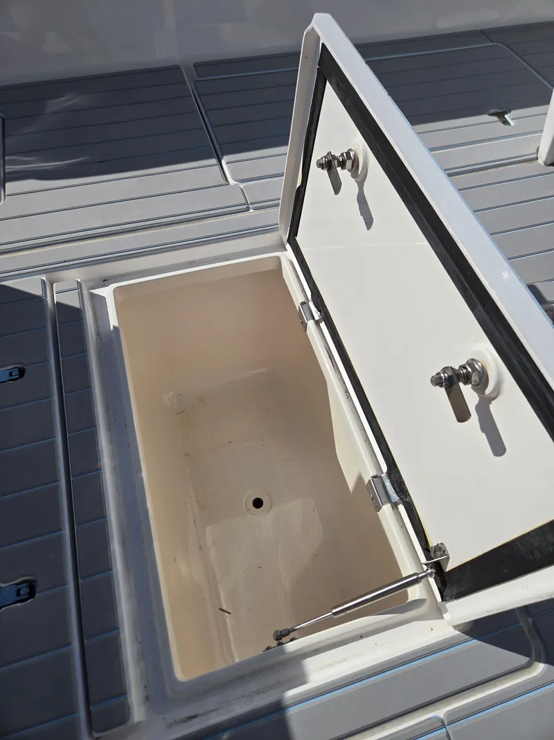 Slide: The Image of Open storage compartment on a 2019 Intrepid 327 boat. - 25