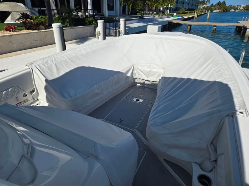 Slide: The Image of 2019 Intrepid 327 boat with cushioned seating at the dock. - 27