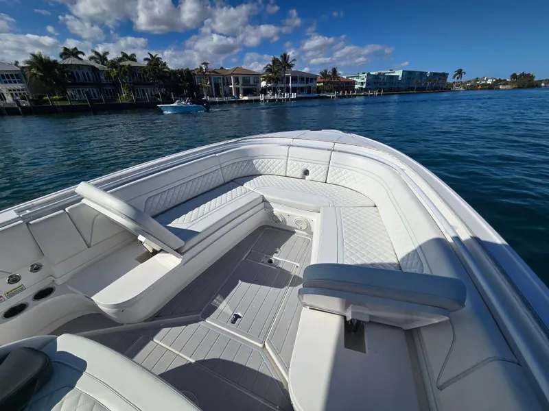 Slide: The Image of 2019 Intrepid 327 boat on calm water with luxurious seating area. - 6