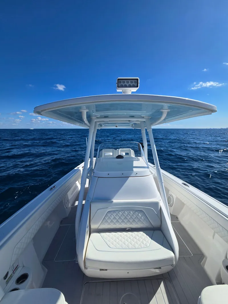 Slide: The Image of 2019 Intrepid 327 boat on open sea under clear sky. - 9
