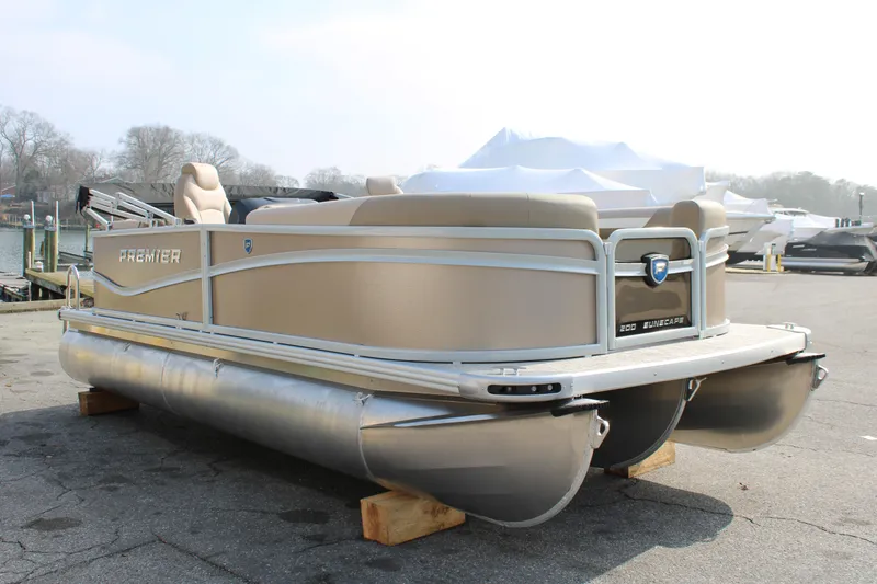 Slide: The Image of 2026 Premier 200 Sunscape RF - CL pontoon boat on a dockside, ready for launch. - 1