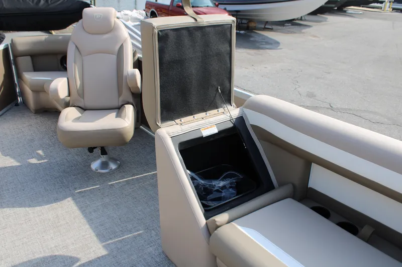 Slide: The Image of 2026 Premier 200 Sunscape RF - CL boat interior with beige seating and storage compartment. - 11