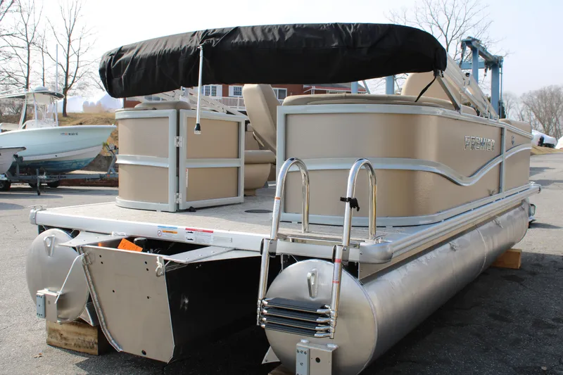 Slide: The Image of 2026 Premier 200 Sunscape RF - CL pontoon boat with canopy, docked outdoors. - 3