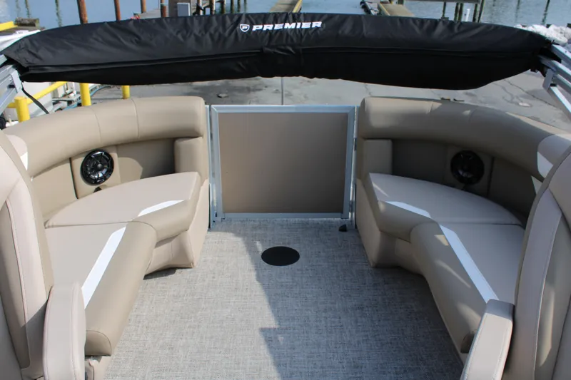 Slide: The Image of 2026 Premier 200 Sunscape RF - CL boat interior with beige seating and speakers. - 4