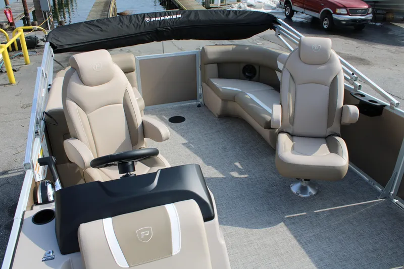 Slide: The Image of 2026 Premier 200 Sunscape RF - CL boat interior with beige seating and steering console. - 5