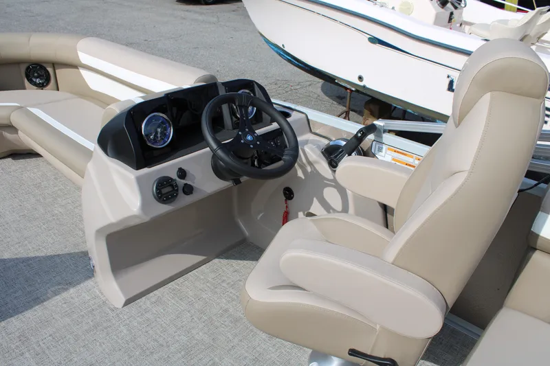 Slide: The Image of 2026 Premier 200 Sunscape RF - CL boat interior with beige seating and steering console. - 7