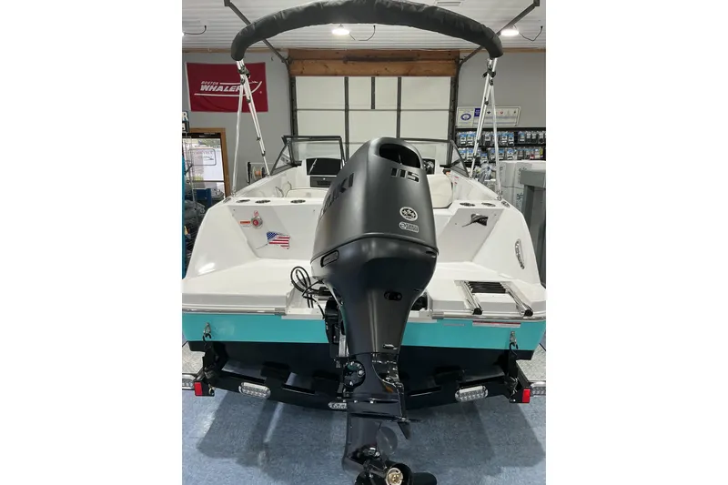 Slide: The Image of 2026 Stingray 172 DC boat with outboard motor in showroom setting. - 4