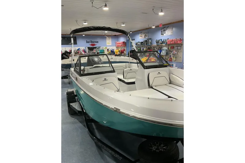 Slide: The Image of 2026 Stingray 172 DC boat displayed in a showroom with modern interior design. - 5