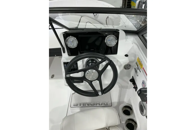 Slide: The Image of 2026 Stingray 172 DC boat dashboard with steering wheel and gauges. - 7
