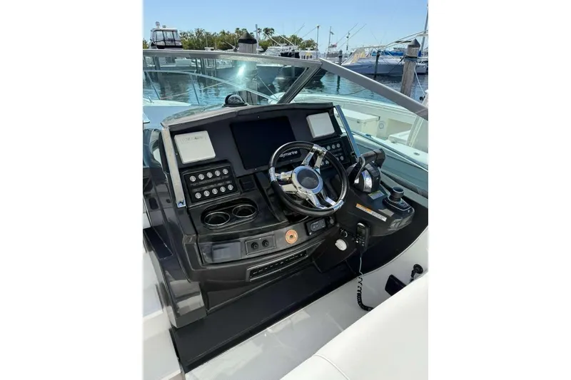 Slide: The Image of 2018 Monterey 335 Sport Yacht helm with modern controls and navigation system. - 6
