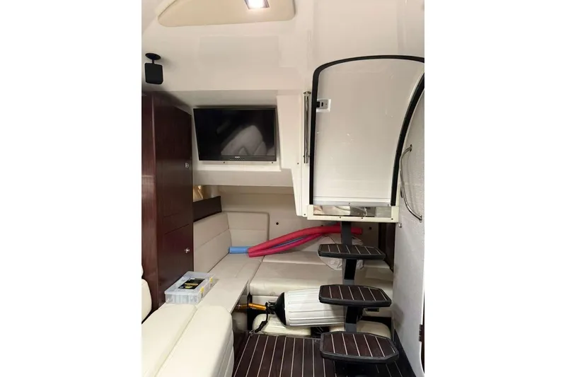 Slide: The Image of Interior of 2018 Monterey 335 Sport Yacht with TV, seating, and stairs. - 7