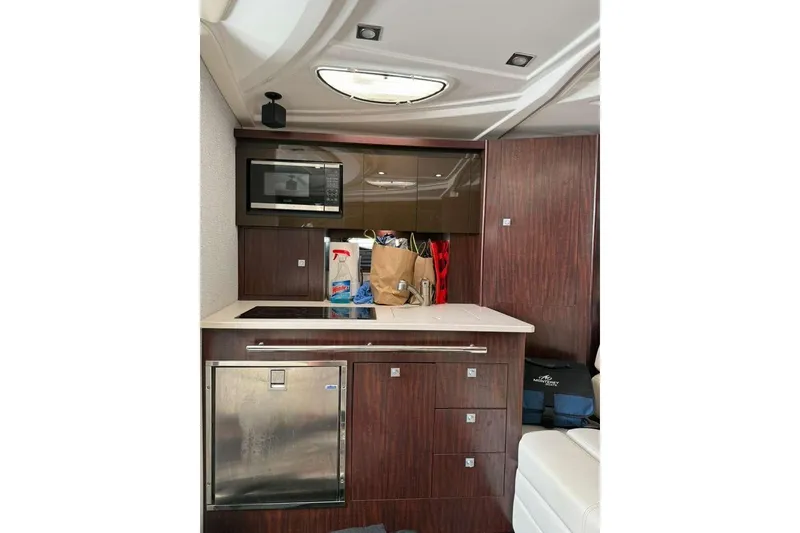 Slide: The Image of Interior of 2018 Monterey 335 Sport Yacht with kitchenette and modern amenities. - 8