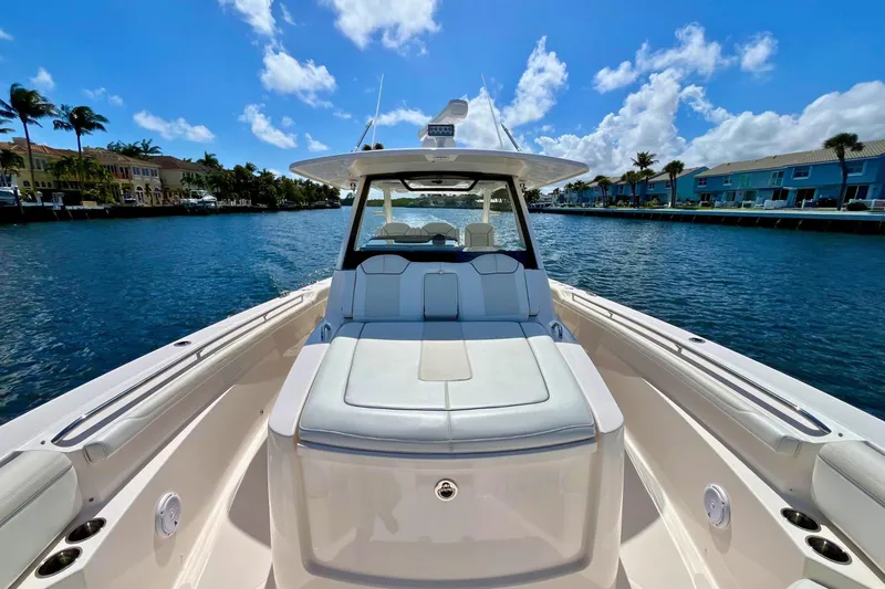 Slide: The Image of 2019 Pursuit S 368 Sport boat on a sunny waterfront, showcasing luxury seating and sleek design. - 14