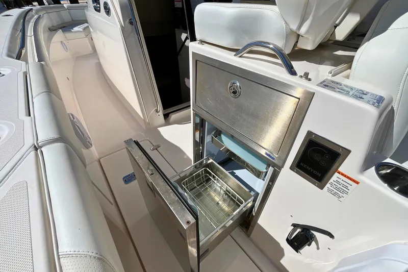 Slide: The Image of 2019 Pursuit S 368 Sport boat interior with stainless steel grill and seating area. - 18