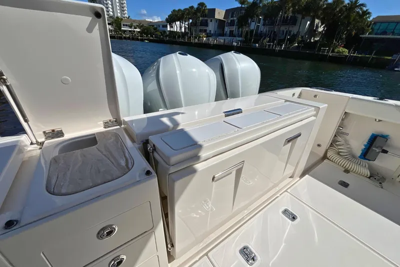 Slide: The Image of 2019 Pursuit S 368 Sport boat deck with storage and triple engines. - 20