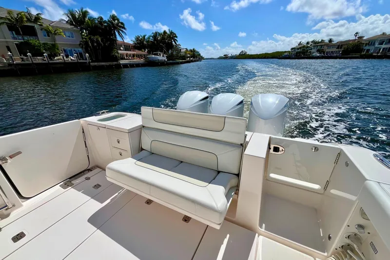 Slide: The Image of 2019 Pursuit S 368 Sport boat cruising on a sunny waterway. - 27