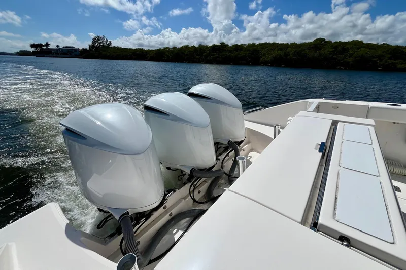 Slide: The Image of 2019 Pursuit S 368 Sport boat with triple outboard engines on a sunny day. - 31