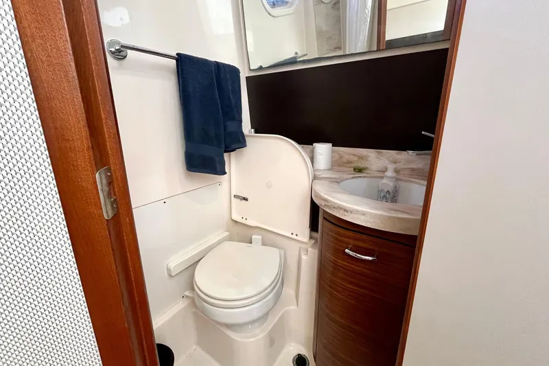 Slide: The Image of 2019 Pursuit S 368 Sport boat bathroom with toilet, sink, and towels. - 34