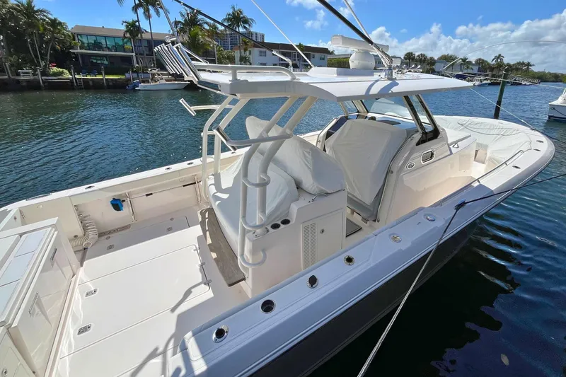 Slide: The Image of 2019 Pursuit S 368 Sport boat docked, featuring spacious deck and modern design. - 35