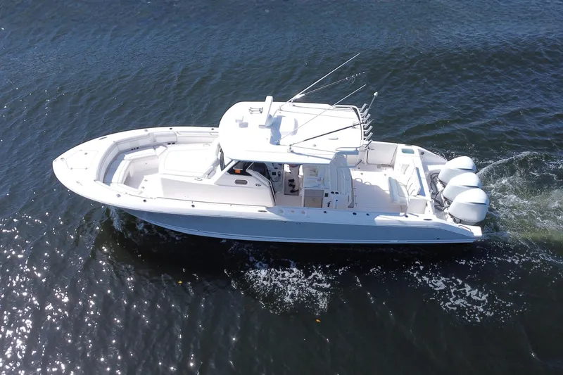 Slide: The Image of 2019 Pursuit S 368 Sport boat cruising on open water, aerial view. - 40