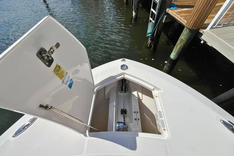 Slide: The Image of 2019 Pursuit S 368 Sport boat anchor compartment open at dockside. - 6