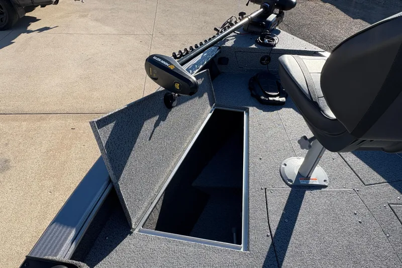 Slide: The Image of 2025 Lund 1875 Pro Guide boat interior with open storage compartment and seating. - 11