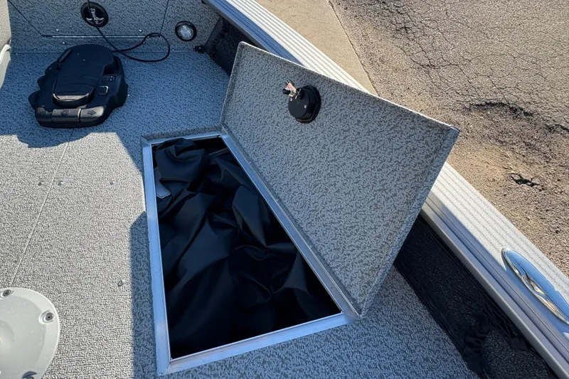 Slide: The Image of Open storage compartment on 2025 Lund 1875 Pro Guide boat deck. - 12