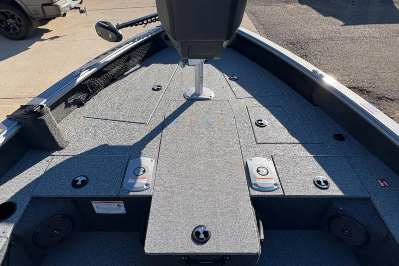 Slide: The Image of 2025 Lund 1875 Pro Guide boat interior with storage compartments and seating. - 13