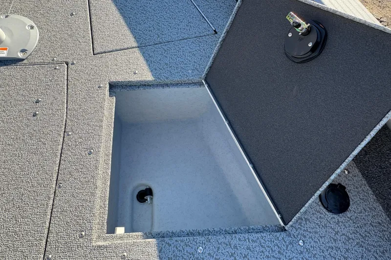 Slide: The Image of Open storage compartment on 2025 Lund 1875 Pro Guide boat deck. - 14