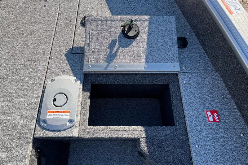 Slide: The Image of 2025 Lund 1875 Pro Guide boat interior with storage compartment and safety features. - 16