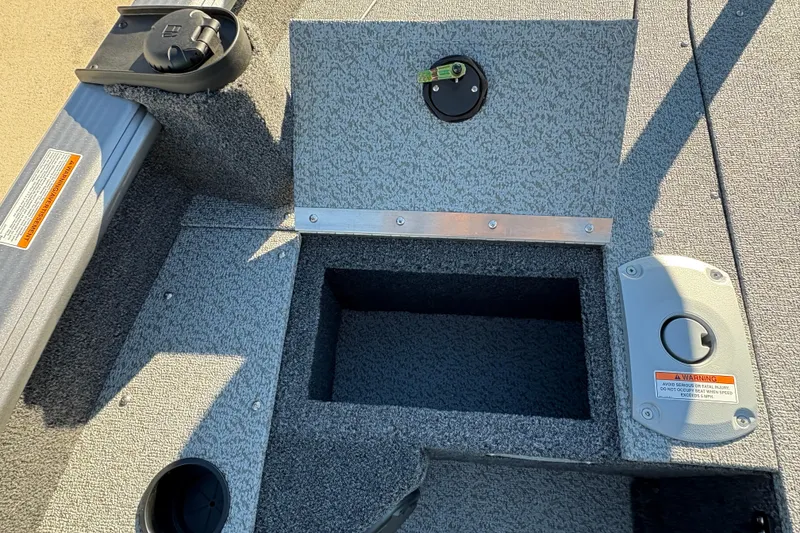 Slide: The Image of 2025 Lund 1875 Pro Guide boat interior with storage compartment and control panel. - 17