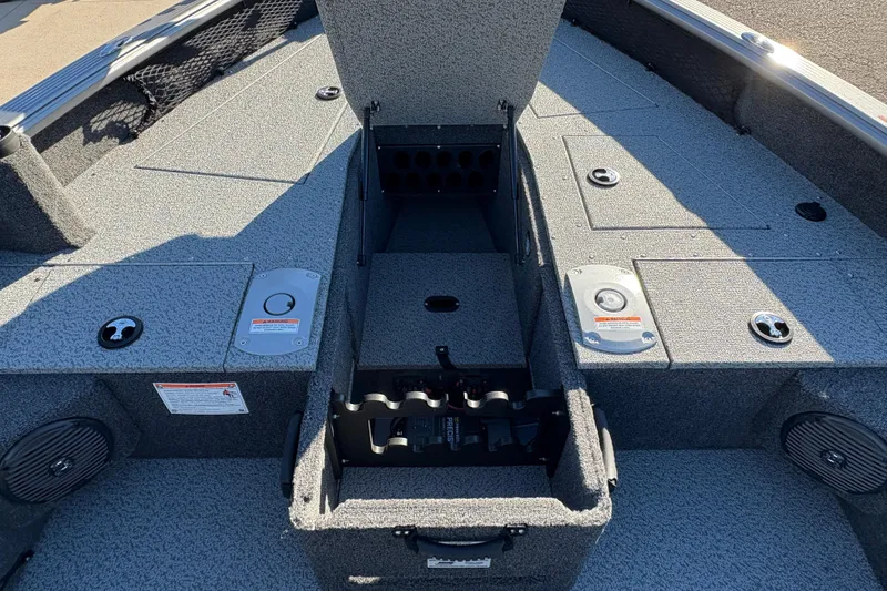 Slide: The Image of 2025 Lund 1875 Pro Guide boat interior with storage compartments and seating area. - 18