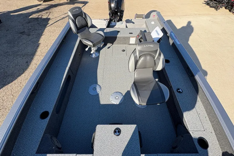 Slide: The Image of 2025 Lund 1875 Pro Guide boat interior with two seats and spacious deck. - 20