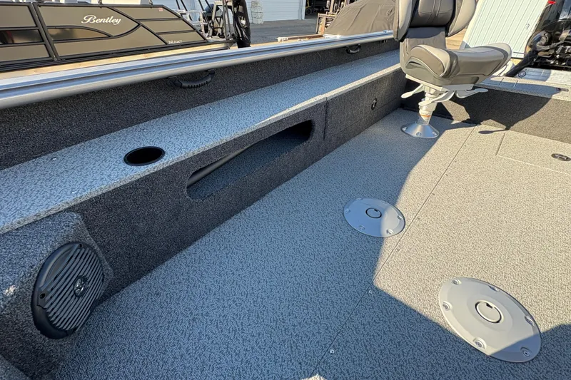 Slide: The Image of 2025 Lund 1875 Pro Guide boat interior with seating and storage compartments. - 21