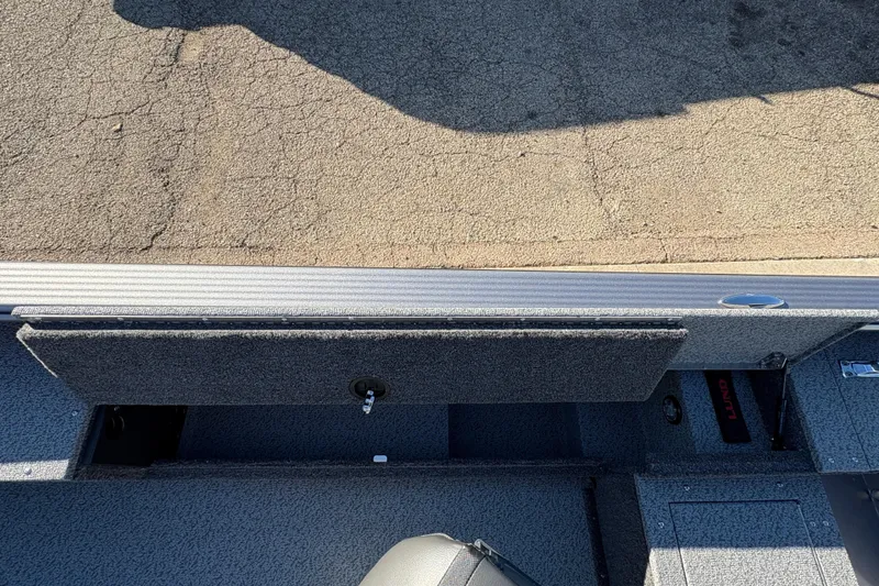 Slide: The Image of 2025 Lund 1875 Pro Guide boat interior with storage compartment open. - 22