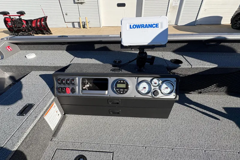 Slide: The Image of 2025 Lund 1875 Pro Guide boat dashboard with Lowrance Elite fish finder and gauges. - 26