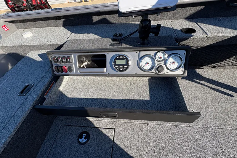 Slide: The Image of 2025 Lund 1875 Pro Guide boat dashboard with gauges and controls. - 27