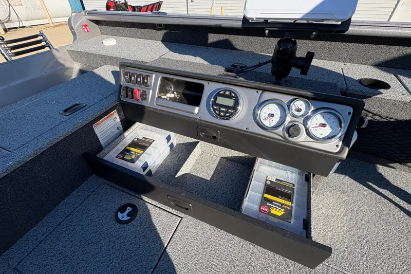 Slide: The Image of 2025 Lund 1875 Pro Guide boat dashboard with gauges and storage compartments. - 28