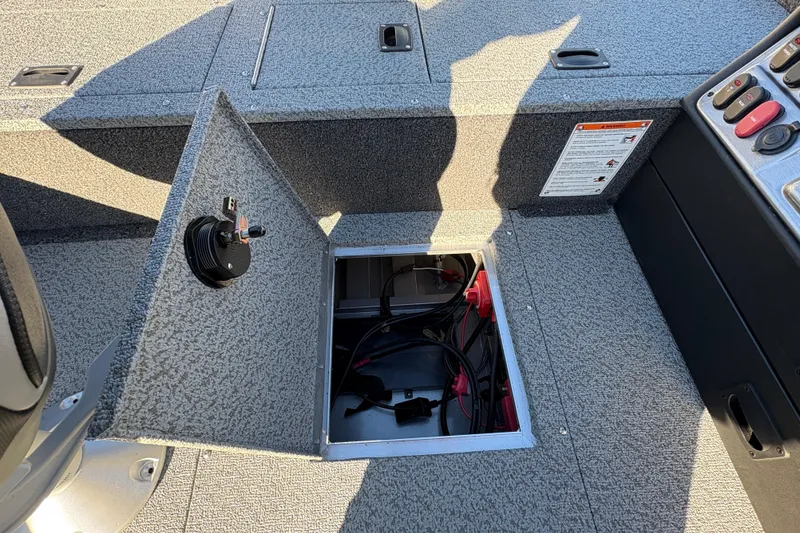 Slide: The Image of Open storage compartment in 2025 Lund 1875 Pro Guide boat, showing interior wiring. - 29